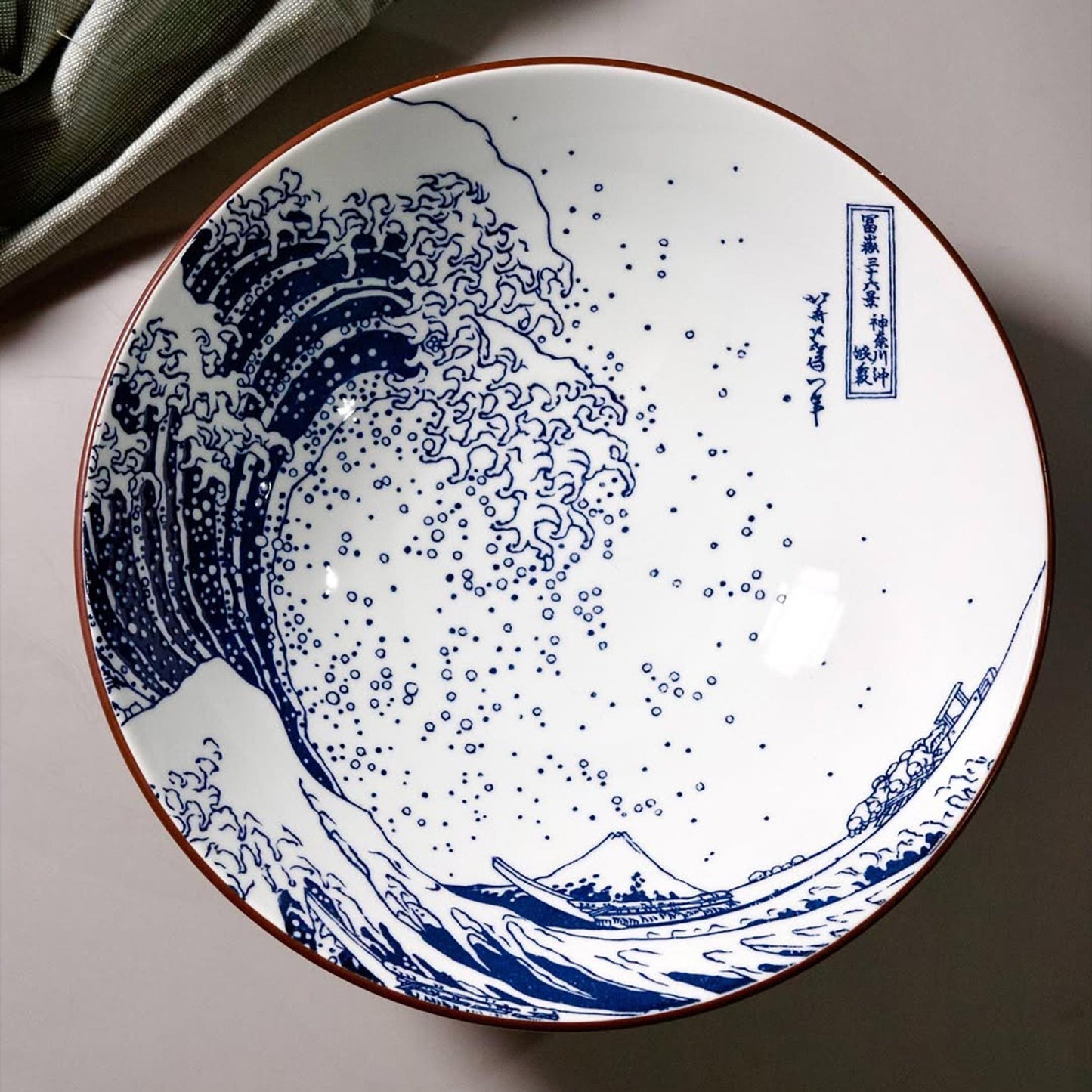 Ceramic plate with blue wave design on a light background