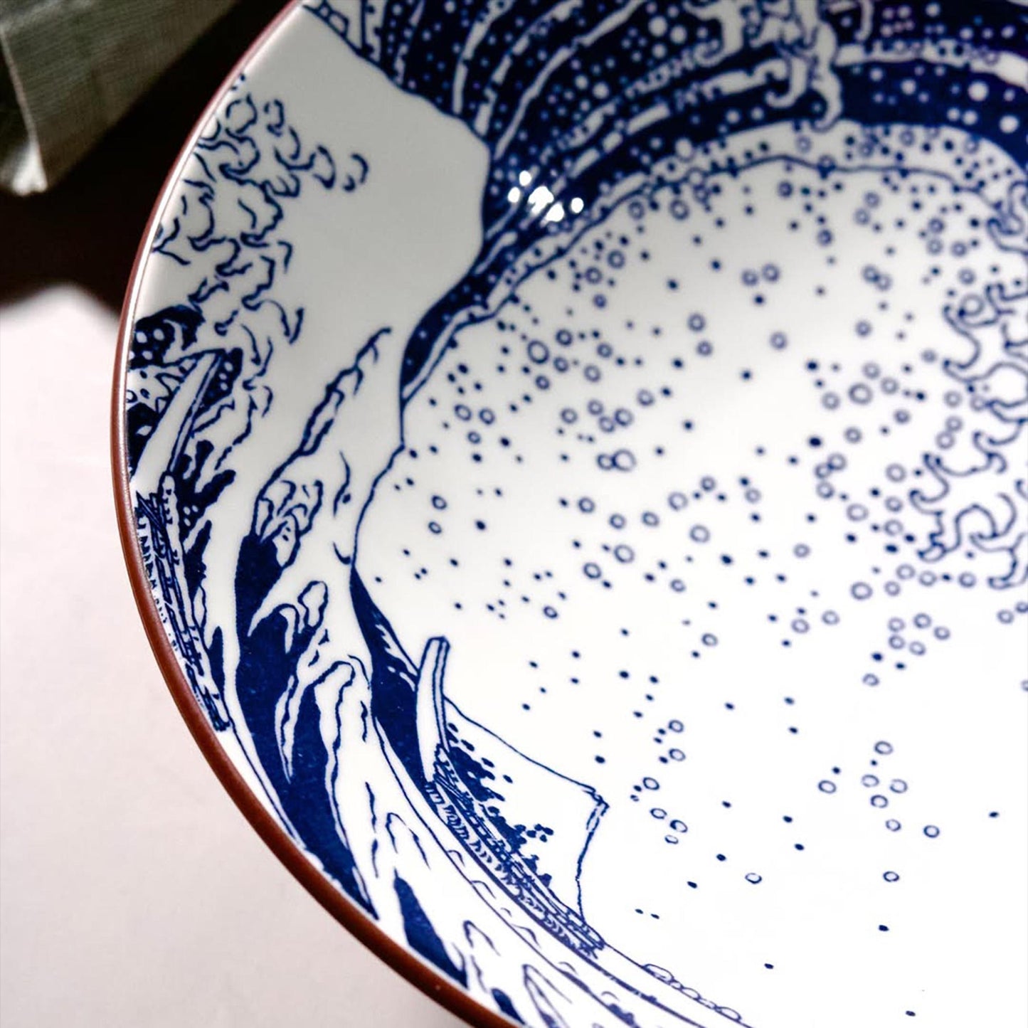 Close-up of a ceramic plate with blue and white design on a light background