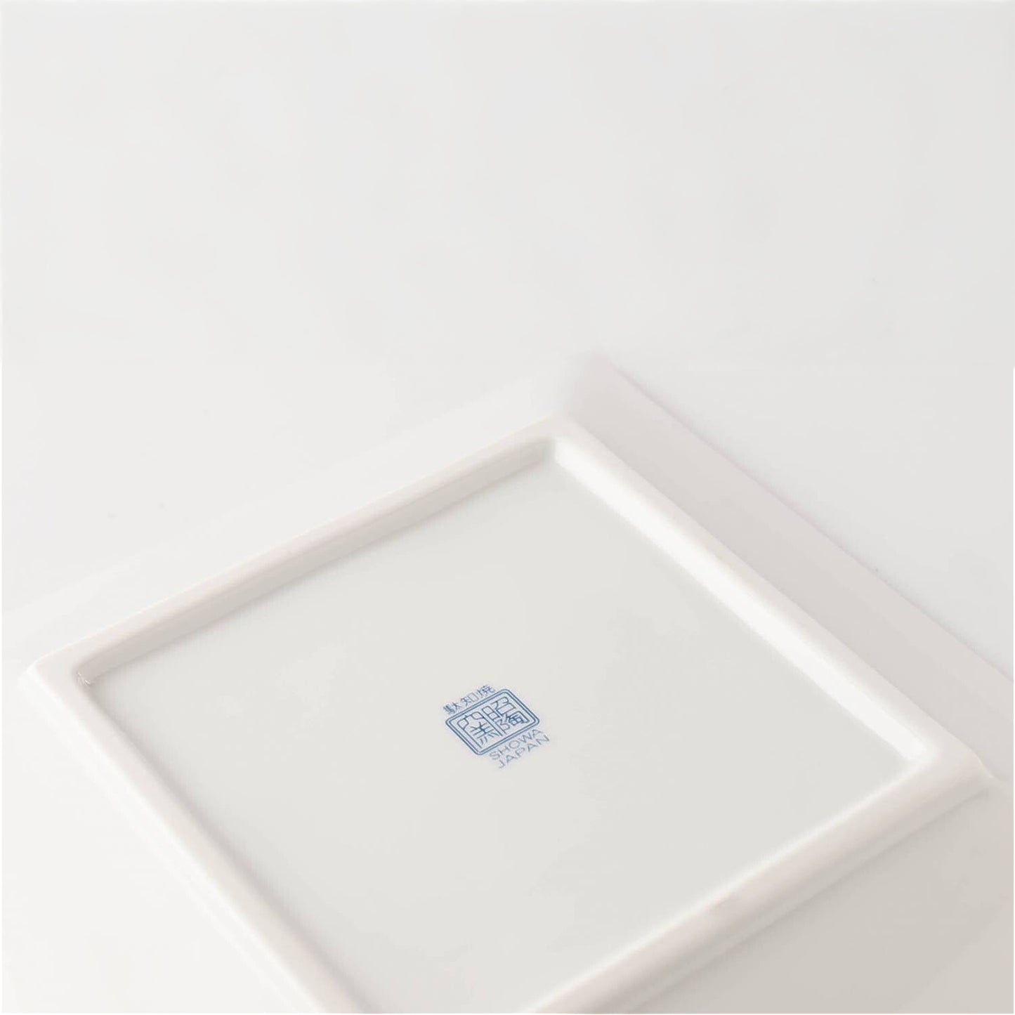 White ceramic plate with a blue logo on a white background