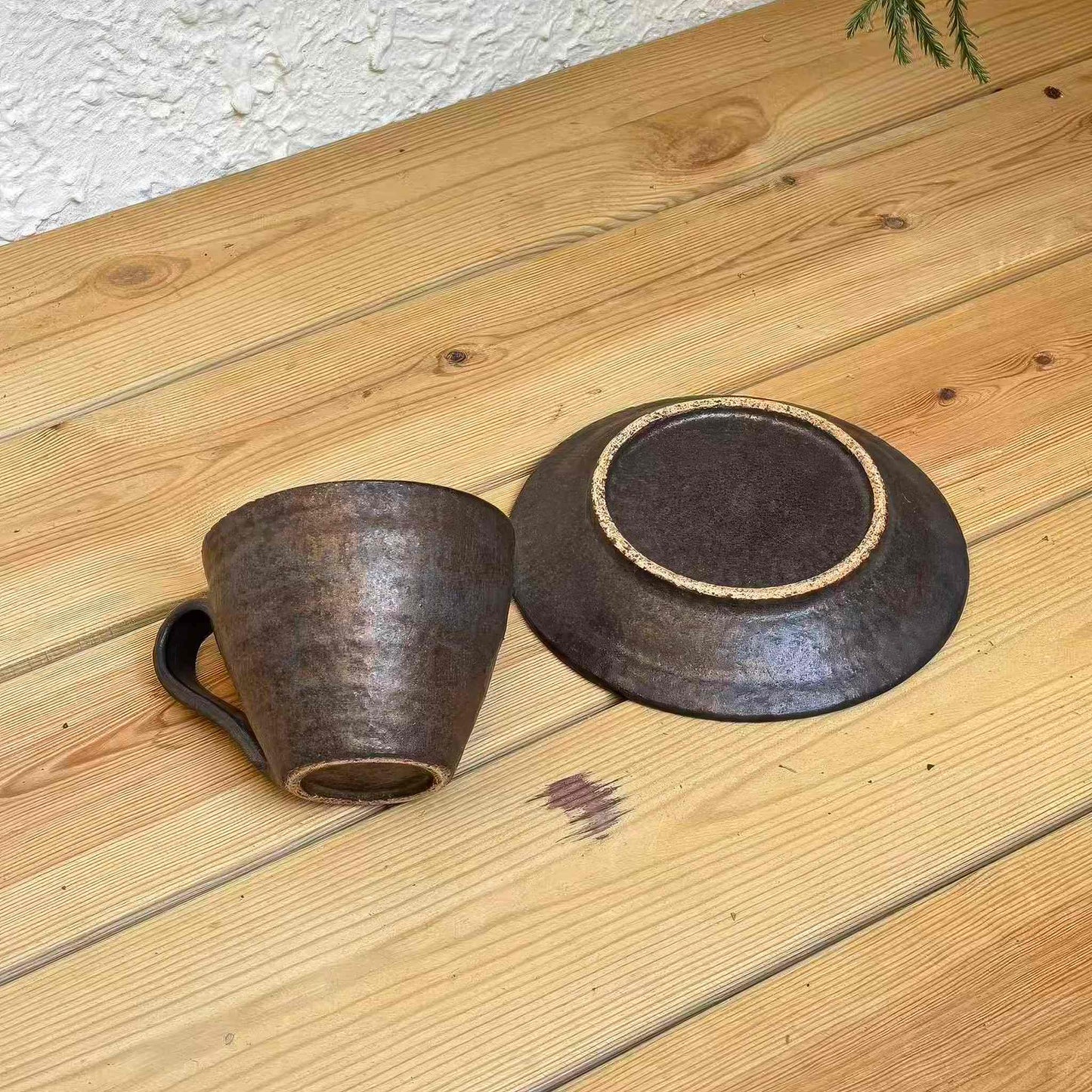 Handcrafted black gold (kurogane) and light snow (kuroyama) ceramic cup and saucer set, exuding a sense of tradition and modernity.