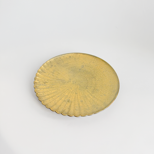 Gold circular object on a white background