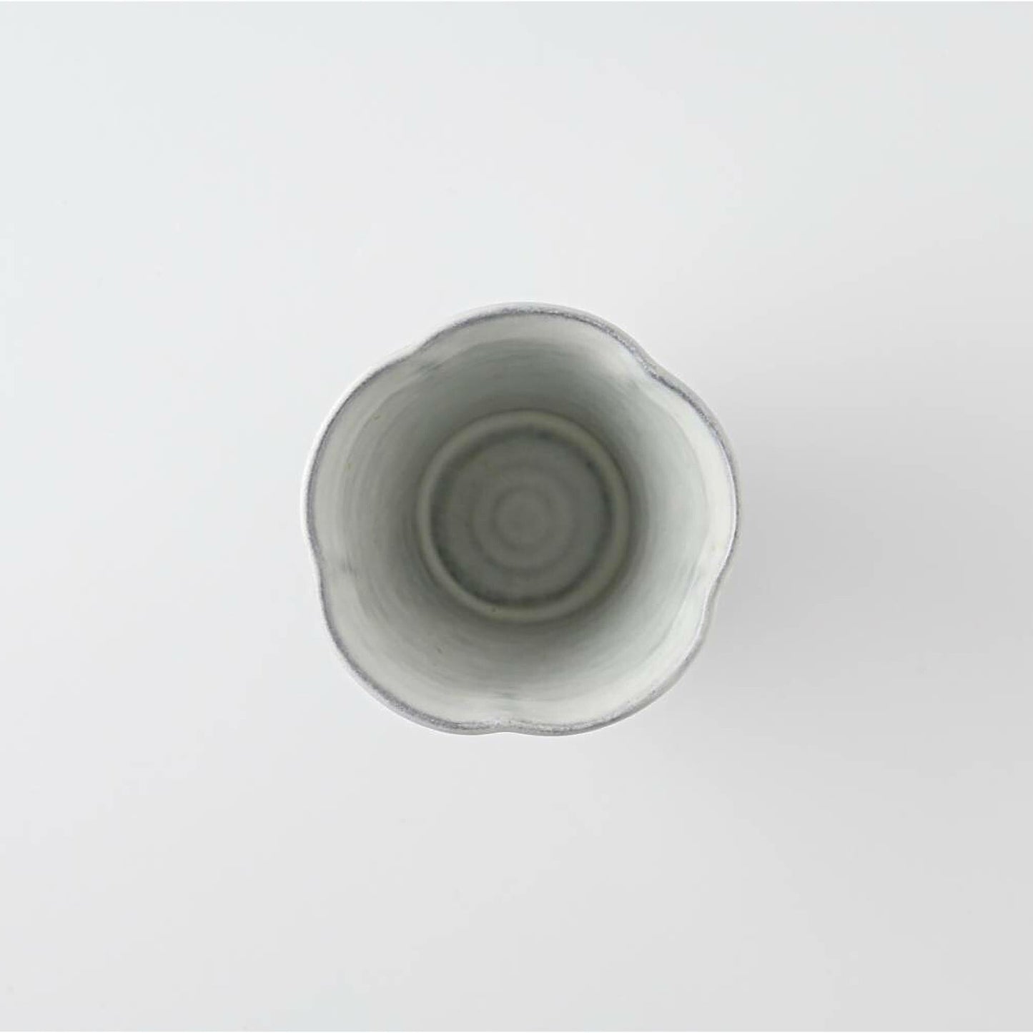White ceramic cup on a light gray background