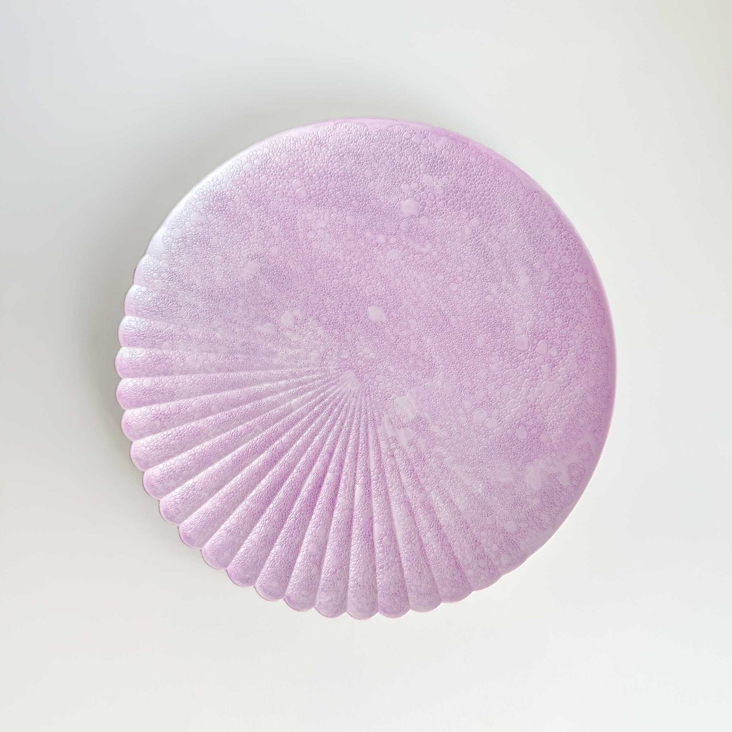 Round purple felt coaster on a light gray background