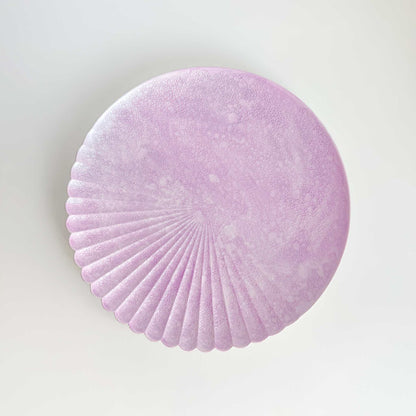 Round purple felt coaster on a light gray background
