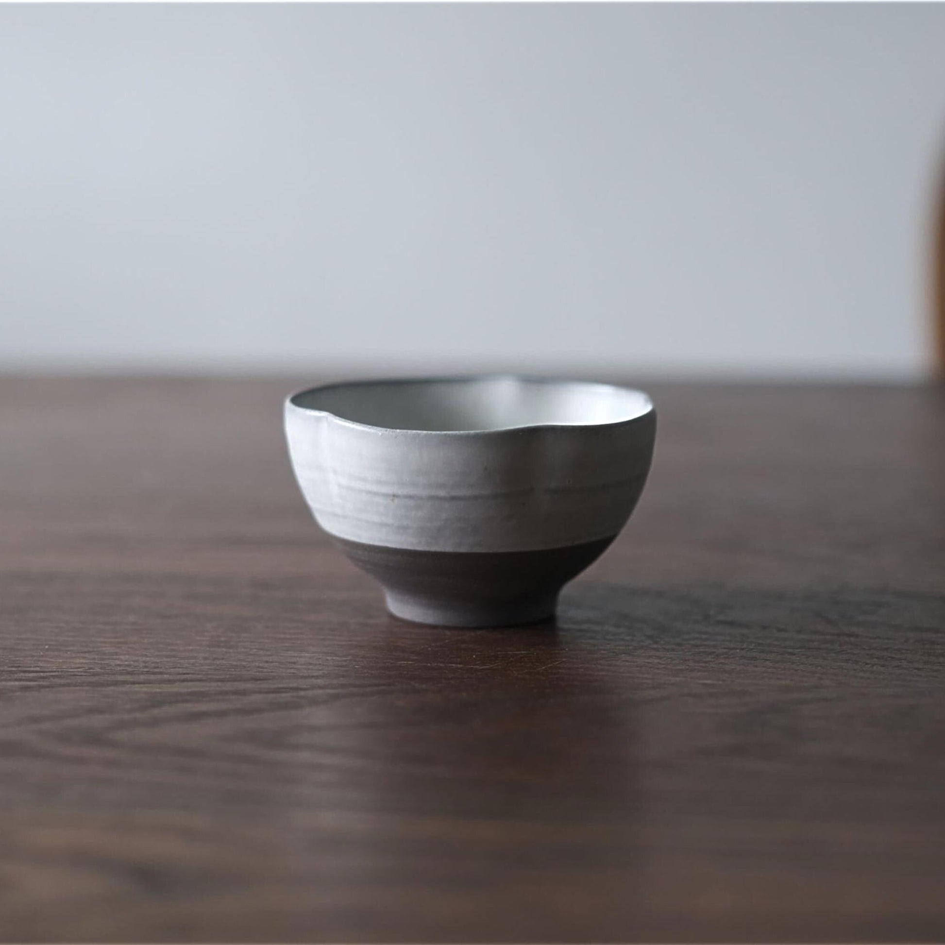Ceramic bowl on a wooden table with a neutral background