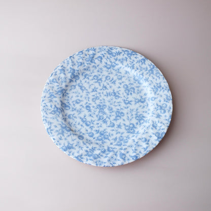 Round blue floral plate on a light gray background