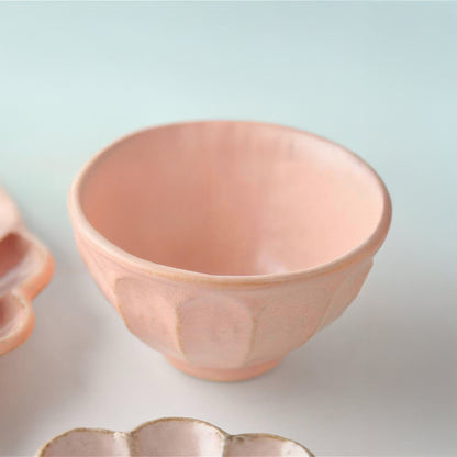 Set of pink ceramic bowls on a light background
