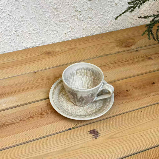Handcrafted Kyuuko cup and saucer set, featuring a striking black gold (kurogane) and light snow (kuroyama) design.