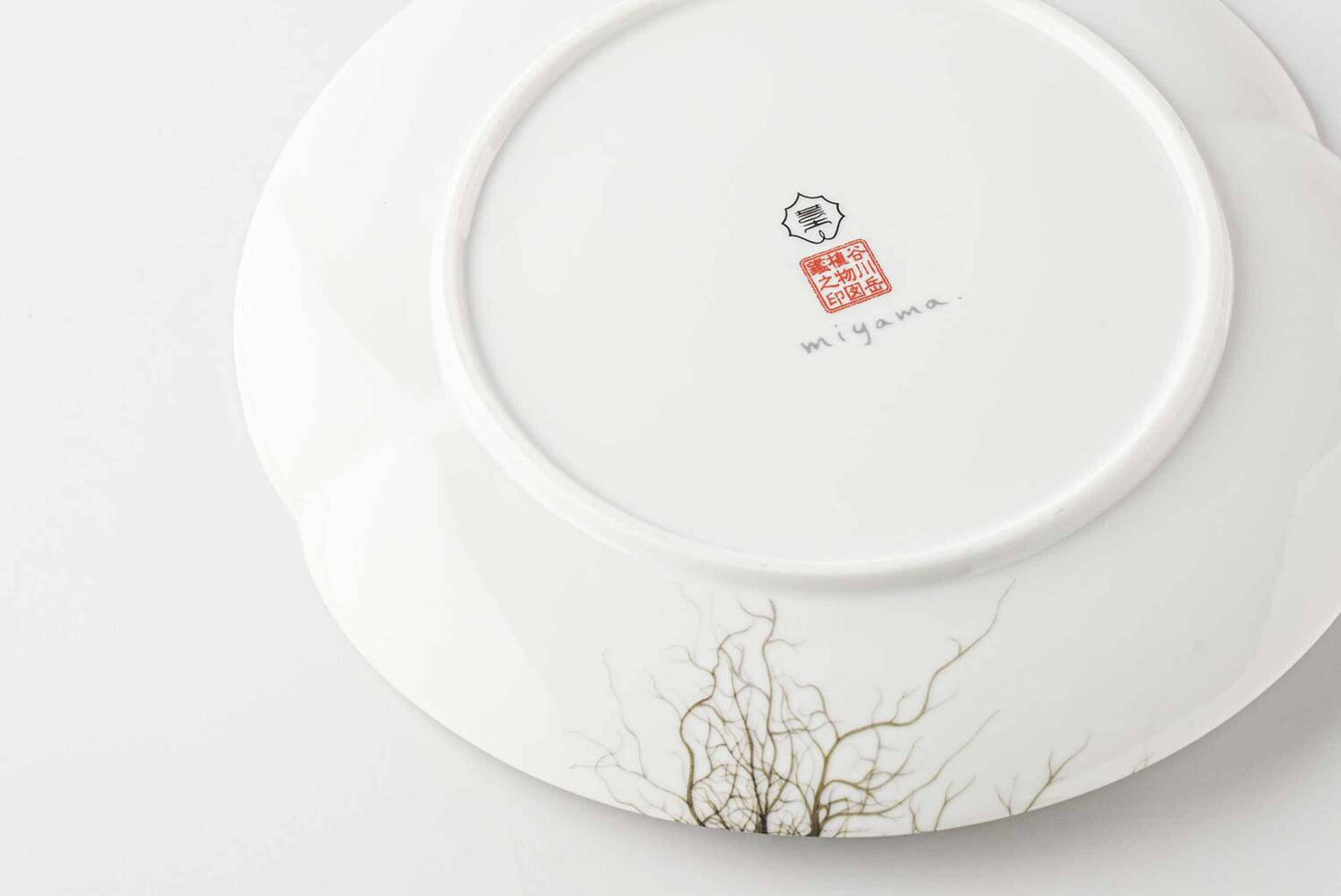 A white, delicate, and intricately designed 8-inch porcelain plate with a botanical design, inspired by the natural beauty of Mount Tanigawa.