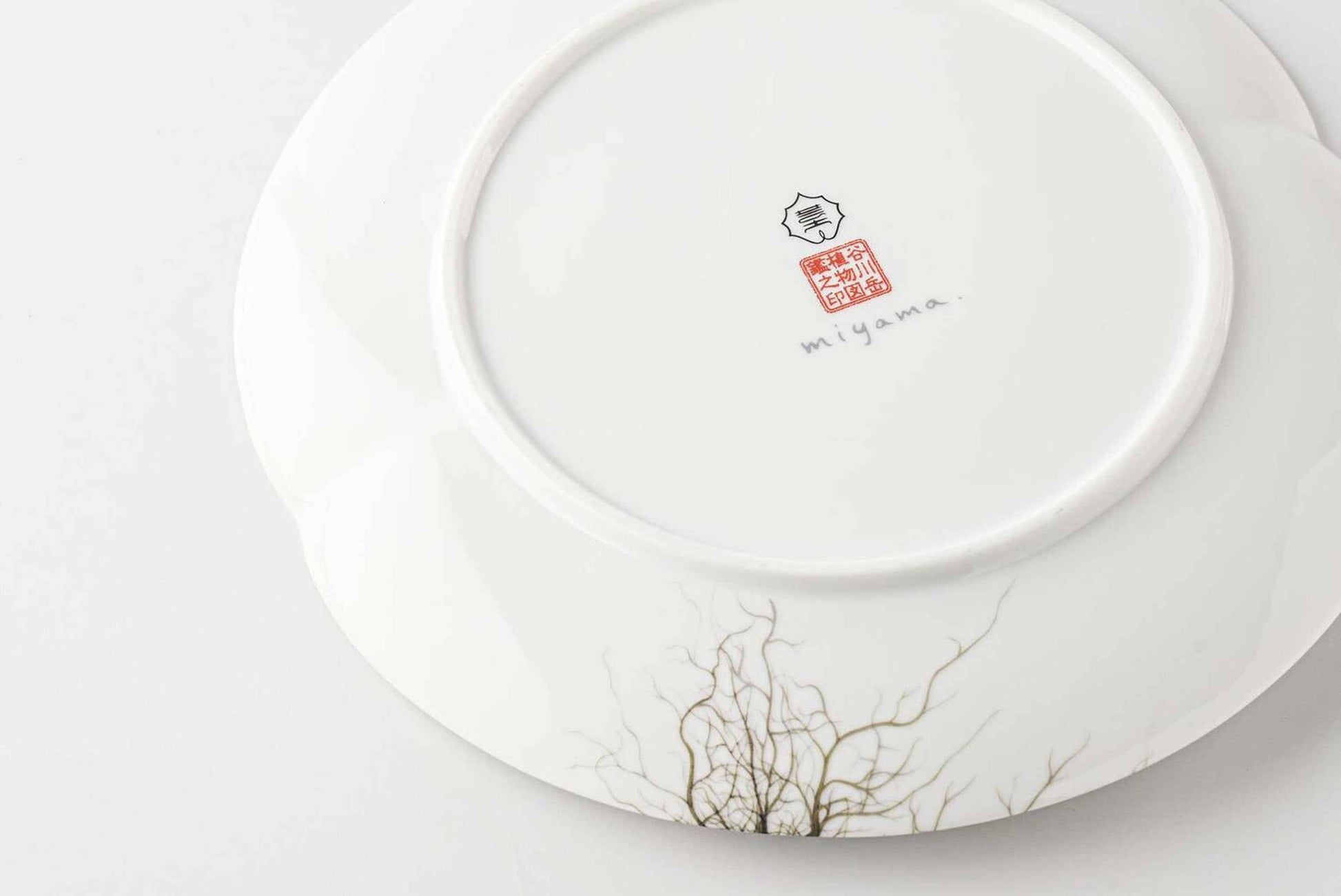 A white, delicate, and intricately designed 8-inch porcelain plate with a botanical design, inspired by the natural beauty of Mount Tanigawa.