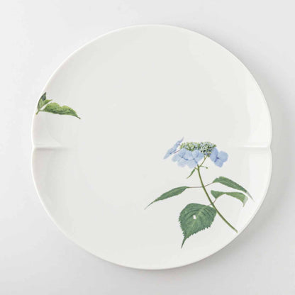 A white, 8-inch porcelain plate with a delicate blue daisy design, set against a plain white background.