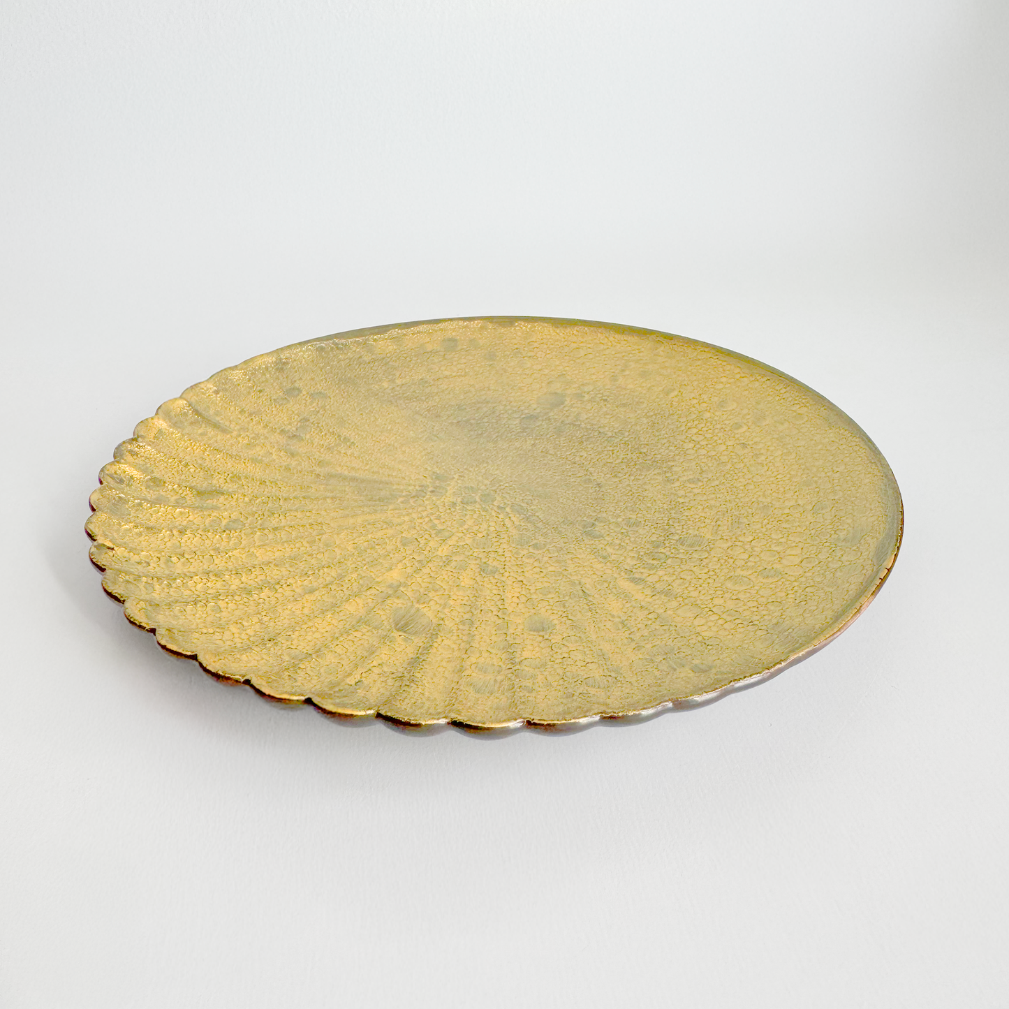 Gold decorative plate on a white background